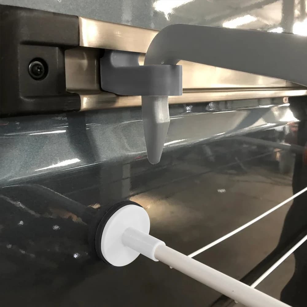 Close-up of a gray RV clothesline bracket mounted on a van's sliding door rail.