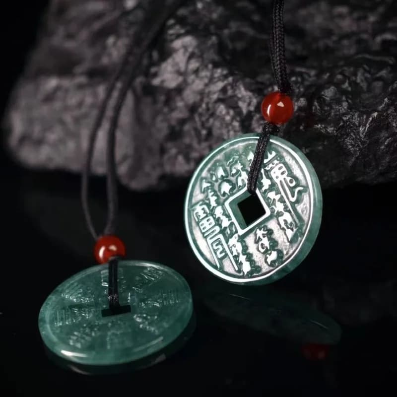 Natural Blue Water Grade A Jadeite Bagua Ghost Money Coin Pendant on a black cord.