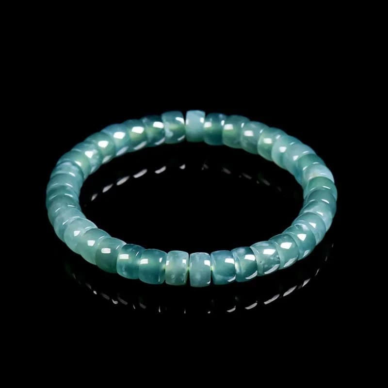 Authentic Grade A Blue Water Jadeite barrel bead bracelet with ice-like translucency.