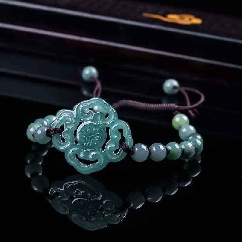 Natural A-grade jadeite bracelet with blue water ice type beads and intricate centerpiece.