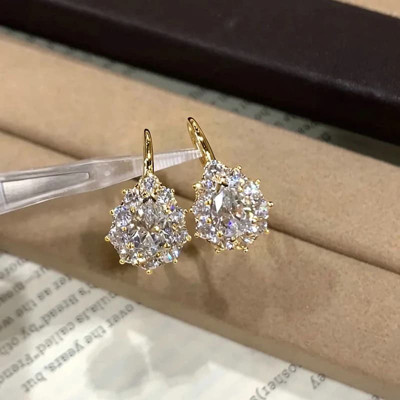 Elegant pear-cut moissanite stones in a 14K gold filled U-shaped hoop earring setting.