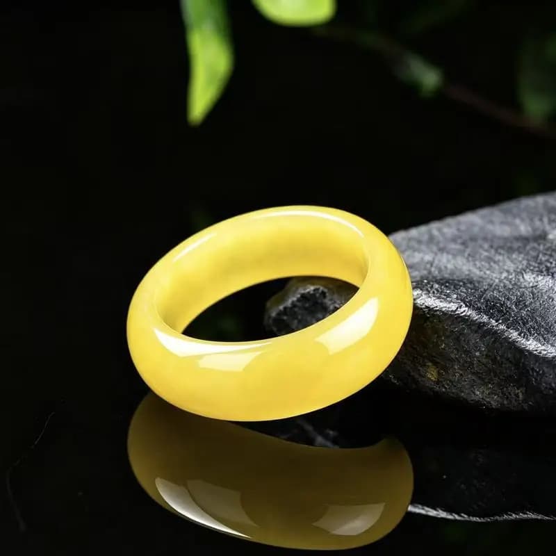 A polished genuine A-grade yellow jadeite ring showing a rich, full yellow color.